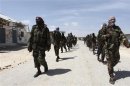 Al Shabaab soldiers patrol in a formation along the streets of Dayniile district in Southern Mogadishu