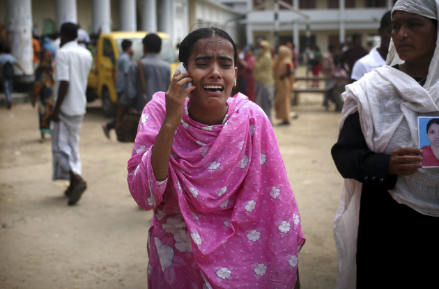 <p> A young lady wails over the phone as she tells her family that she had identified one of the many bodies at a morgue to be her relative, Saturday, May 4, 2013 in Savar, near Dhaka, Bangladesh. In the aftermath of a building collapse that killed more than 530 people, Bangladesh's garment manufacturers may face a choice of reform or perish. (AP Photo/Wong Maye-E)
