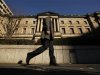 A man walks past the Bank of Japan headquarters in Tokyo