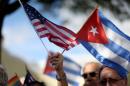 A protester holds an American flag and a Cuban one as she joins with others opposed to U.S. President Barack Obama's announcement earlier in the week of a change to the US Cuba policy at Jose Marti park on December 20, 2014 in Miami, Florida