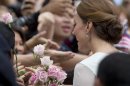 Kate, the Duchess of Cambridge meets well-wishers during a walk through a central city park in Kuala Lumpur, Malaysia, Friday, Sept. 14, 2012. (AP Photo/Mark Baker)
