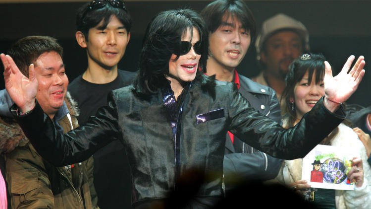 FILE - In this March 9, 2007 file photo, U.S. pop singer Michael Jackson greets his fans during an event "Fan Appreciation Day" in Tokyo. Michael Jackson's estate is suing a man and three companies in Japan, alleging they are using the name and likeness of the late pop star on key chains, mugs and other products without permission. The lawsuit filed in Tokyo District Court last month, Sept. 2013, does not seek money but demands the actions stop. It names Ryosuke Matsuura and three companies, Michael Jackson Asian Rights, Michael Jackson Enterprises and Michael Jackson World. (AP Photo/Itsuo Inouye, File)