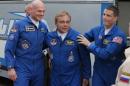 European Space Agency's astronaut Alexander Gerst, left, Russian cosmonaut Maxim Suraev, center, and NASA astronaut Reid Wiseman, crew members of the latest mission to the International Space Station, ISS, walk to a bus from a hotel, prior to the launch of Soyuz-FG rocket at the Russian leased Baikonur cosmodrome, Kazakhstan, Wednesday, May 28, 2014. (AP Photo/Dmitry Lovetsky)