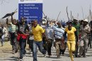 Mineworkers take part in a march outside the Anglo American mine in South Africa's North West Province