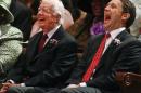 Former President Jimmy Carter, left, and his grandson, Georgia Democratic candidate for governor Jason Carter, react to a joke from the pulpit Sunday, Oct. 12, 2014 at Mt. Zion Baptist Church in Albany, Ga. After an absence of four decades, the former president is returning to the campaign trail this year on behalf of Jason Carter, who's challenging incumbent Republican Gov. Nathan Deal. (AP Photo/Phil Sears)