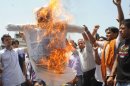 Indian activists burn an effigy of Indian Cabinet Minister for Petroleum and Natural Gas, Jaipal Reddy