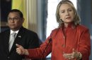 U.S. Secretary of State Clinton speaks to reporters next to Burma's Foreign Minister Wunna after their meeting at the State Department in Washington