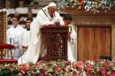 Pope Francis kneels as he leads the Christmas night Mass in Saint Peter's Basilica at the Vatican