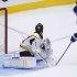 Toronto Maple Leafs defenseman Dion Phaneuf, right, scores past Boston Bruins goalie Tuuka Rask, left, during third period NHL hockey playoff action in Toronto on Sunday, May 12, 2013. (AP Photo/The Canadian Press, Nathan Denette)