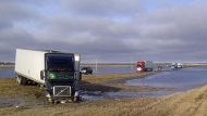 Road flooding in 2011. A semi is in the ditch at a water-covered section of the Trans-Canada Highway at Indian Head, Sask.