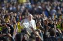 Pope Francis salutes the crowd as he arrives for his general audience in St Peter's square at the Vatican on November 6, 2013