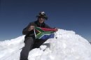 In this undated photo released on Monday Aug. 27, 2012 by the family of South African adventurer David du Plessis, 24, du Plessis holds up the flg of South Africa as he reaches the summit of Mount Mismi located in the Andes mountain range of Peru. David du Plessis, 24, was shot three times and robbed by two young men Saturday, Aug. 25, while seeking to follow the Amazon River from its origin to its mouth. He is now in stable condition at a Lima hospital. (AP Photo/David du Plessis family)
