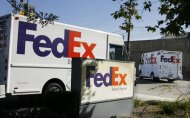 Federal Express trucks head out for deliveries from a FedEx station in Los Angeles, California June 18, 2008. REUTERS/Fred Prouser