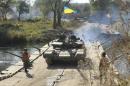 Tanks of the Ukrainian armed forces make a crossing during withdrawal near the village of Nyzhnje in Luhansk region