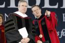 Commencement speaker former Florida Gov. Jeb Bush, left, arrives on stage with Liberty University president, Jerry Falwell Jr., for commencement ceremonies in Williams Stadium at the school in Lynchburg, Va., Saturday, May 9, 2015. (AP Photo/Steve Helber)