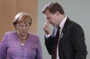 German Chancellor Merkel chats with German government spokesman Seibert before weekly cabinet meeting in Berlin