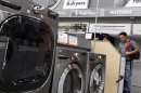 Shoppers look at washers and dryers at a Home Depot store in New York