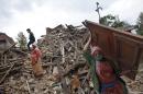 Nepalese earthquake-affected victims salvage belongings from their damaged homes in Lalitpur, on the outskirts of Kathmandu, Nepal, Thursday, April 30, 2015. In mere seconds, Saturday's earthquake devastated a swathe of Nepal. Three of the seven World Heritage sites in the Kathmandu Valley have been severely damaged, including Durbar Square with pagodas and temples dating from the 15th to 18th centuries, according to UNESCO, the United Nations cultural agency. (AP Photo/Niranjan Shrestha)