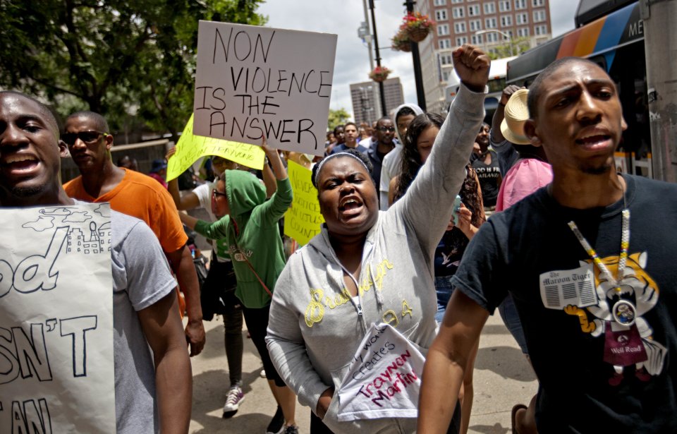 Lisa Archer, 24, of Atlanta, center, chants as protestors march, Sunday, July 14, 2013, in Atlanta the day after George Zimmerman was found not guilty in the 2012 shooting death of teenager Trayvon Martin. From New York to California, outrage over the acquittal in George Zimmerman's murder trial poured from street demonstrations and church pulpits. (AP Photo/David Goldman)