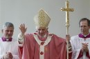 Pope Benedict XVI waves during his pastoral visit to St. Patrick Church on the outskirts of Rome