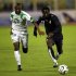 Zimbabwe's Ndlovu and Ghana's Dramani run after the ball during their African Nations Cup soccer match in Egypt