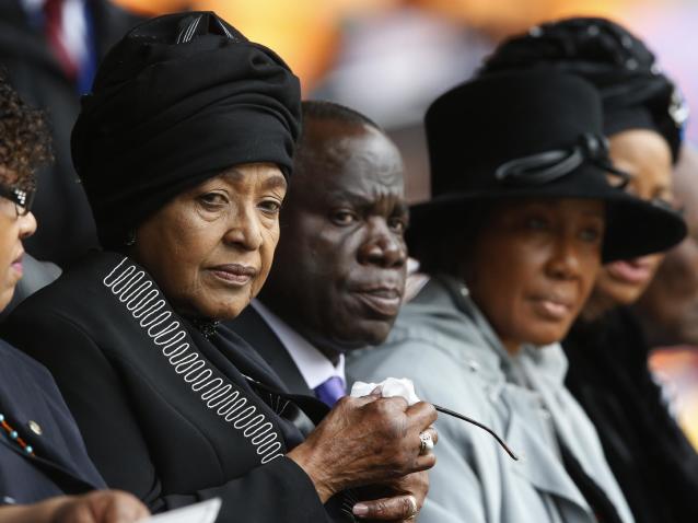 Winnie Madikizela-Mandela, left, Nelson Mandela's former wife, attends the memorial service for former South African president Nelson Mandela at the FNB Stadium in the Johannesburg, South Africa township of Soweto, Tuesday Dec. 10, 2013. (AP Photo/Matt Dunham)