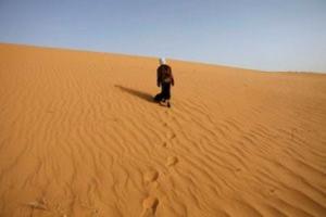 File photo of a girl walking near Ouled Said ksar, a fortified village on the outskirts of the Sahara oasis town of Timimoun
