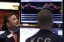 FILE - In this Sept. 1, 2015 file photo, specialist Thomas Facchine, left, works on the floor of the New York Stock Exchange. Fears about China's slowdown and a coming U.S. interest rate hike have sent global stock markets into a fidgety freefall. (AP Photo/Richard Drew, File)