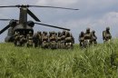 Japanese Ground Self-Defense Force's 1st Airborne Brigade soldiers prepares to board CH-47 helicopter for parachute drop training during their military drill in Susono