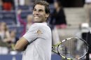 Rafael Nadal of Spain hits tennis balls into the crowd after defeating Rogerio Dutra Silva of Brazil at the U.S. Open tennis championships in New York