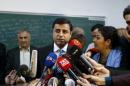 Demirtas, co-chairman of the pro-Kurdish Peoples' Democratic Party (HDP), talks to the media before casting his ballot at a polling station