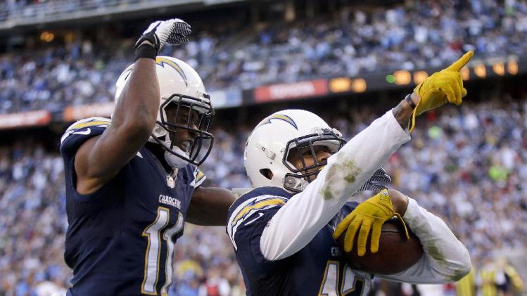 San Diego Chargers wide receiver Keenan Allen, right, celebrates his touchdown with teammate wide receiver Eddie Royal against the Oakland Raiders during the first half of an NFL football game on Sunday, Dec. 22, 2013, in San Diego