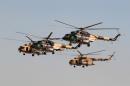 Iraqi helicopters fly over the Basmaya military base during a training session on the outskirts of Baghdad, on November 25, 2011