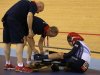 Britain's Philip Hindes sits on the ground after falling during their track cycling men's team sprint qualifying heats at the Velodrome during the London 2012 Olympic Games
