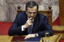 Greece's PM Antonis Samaras gestures during a parliament session in Athens