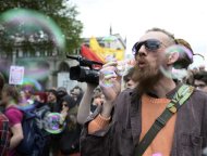 A supporter of a Unite Against Fascism (UAF) counter-demonstration to another one held by the far-right British National Party (BNP) against the killing   of a British soldier, blows bubbles in central London June 1, 2013. REUTERS/Dylan Martinez