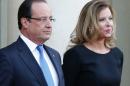 FILE - In this Sept. 3, 2013 file photo, French president Francois Hollande and his companion Valerie Trierweiler wait for German President Joachim Gauckand, at the Elysee Palace, in Paris. France's former first lady says she and the president had grown detached recently but she was caught totally by surprise by his affair with an actress. Trierweiler told the weekly Paris-Match, where she long worked as a journalist, that she didn't believe rumors about the affair until a gossip magazine report earlier this month. 