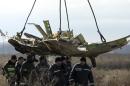 Crane transports a piece of the Malaysia Airlines flight MH17 wreckage at the site of the plane crash near the village of Hrabove (Grabovo) in Donetsk region