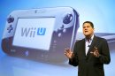 FILE - In this Sept. 13, 2012 photo, Reggie Fils-Aime, president and chief operating officer of Nintendo of America, discusses the upcoming Wii U gaming console, in New York. Much like the iPad, the curvey GamePad features a touchscreen that can be manipulated with the simple tap or swipe of a finger, but it's surrounded by the kinds of buttons, bumpers, thumbsticks and triggers that are traditionally found on a modern-day game controller. The gaming console will start at $300 and go on sale in the U.S. on Sunday, Nov. 18, in time for the holidays, the company said. (AP Photo/Mark Lennihan, File)