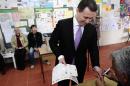Macedonian PM Gruevski gets his finger marked at a polling station in Skopje