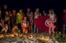 People place lit candles in the sand in front of the Imperial Marhaba Hotel, where a gunman had carried out an attack, in Sousse, Tunisia