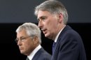 Defense Secretary Chuck Hagel and British Defense Secretary Philip Hammond participate in a joint news conference at the Pentagon, Thursday, May 2, 2013, where the talked about Syria. (AP Photo/J. Scott Applewhite)