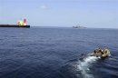 A rigid-hull inflatable boat from the guided-missile destroyer USS Bulkeley (DDG 84) approaches the Japanese-owned commercial oil tanker M/V Guanabara in the Arabian Sea off the Coast of Somalia