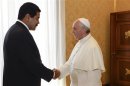 Pope Francis shakes hands with Venezuela's President Nicolas Maduro during a meeting at the Vatican