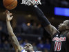 Seton Hall guard Aaron Cosby (1) shoots against Louisville center Gorgui Dieng (10) during the second half of an NCAA college basketball game on Wednesday, Jan. 9, 2013, in Newark, N.J. Louisville won 73-58. (AP Photo/Julio Cortez)