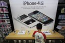 A boy checks an iPhone at an Apple booth at an electronic store in Tokyo Friday, Aug. 31, 2012. A Tokyo court has ruled that Samsung did not infringe on an Apple patent, in the latest development in the legal battle between the two technology titans. (AP Photo/Itsuo Inouye)