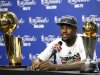 Miami Heat's James sits with the Larry O'Brien trophy and the NBA Finals MVP trophy after his team won the title by defeating the Oklahoma City Thunder in Game 5 of the NBA basketball finals in Miami