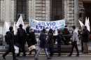 Residents walk past a banner reading "Silvio, Italy believes in you" hung outside former Prime Minister Silvio Berlusconi's home in central Rome