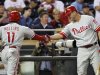 Philadelphia Phillies Jimmy Rollins is congratulated by teammate Jim Thome in their win against the Twins