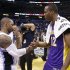 Former teammates Orlando Magic's Jameer Nelson, left, and Los Angeles Lakers' Dwight Howard (12) shake hands before leaving the court at the end of an NBA basketball game, Tuesday, March 12, 2013, in Orlando, Fla. Los Angeles won the game 106-97.(AP Photo/John Raoux)
